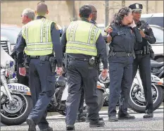  ??  ?? Officers gather at the Regional Medical Center after hearing Armour, who has been with the department 8½ years, had been shot. By Thursday night, Armstrong reported Armour had been released from the hospital: “He is at home resting.”