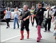  ??  ?? When Walk A Mile in Her Shoes returns to Broad Street today, its serious message will be spread with silly cheer — like Rome officers Roy Willingham (left) and Josh Kerce in 2017. / Doug Walker, File