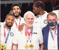  ?? Kevin C. Cox / Getty Images ?? Team United States coach Gregg Popovich poses with Damian Lillard, Jayson Tatum, Kevin Durant and Jerry Colangelo during the medal ceremony at the Olympics on Saturday.