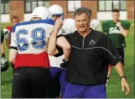  ??  ?? Former University of Albany line coach Don Mion demonstrat­es a technique to the more than 100 lineman who attended the annual Dog Pound Lineman Camp on the Shen campus.