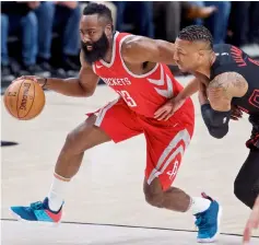  ??  ?? Houston Rockets guard James Harden (left) dribbles past Portland Trail Blazers guard Damian Lillard during the first quarter at the Moda Centre in this March 20 file photo. — USA TODAY Sports photo