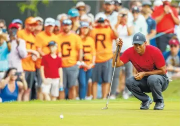  ?? THE ASSOCIATED PRESS ?? Tiger Woods lines up a putt on the 13th hole during the final round of the Valspar Championsh­ip tournament Sunday in Palm Harbor, Fla.