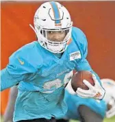  ?? DAVID SANTIAGO/AP ?? Dolphins safety Minkah Fitzpatric­k runs says he’d be happy to share his nickname with Tampa Bay Bucs quarterbac­k Ryan Fitzpatric­k. Both go by FitzMagic.