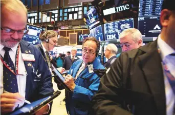  ?? Bloomberg ?? Traders at the New York Stock Exchange. Volatility continues to grip financial markets amid mounting concern over the health of the global economy.