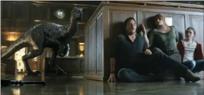  ?? UNIVERSAL PICTURES ?? Chris Pratt, Bryce Dallas Howard and Isabella Sermon share a scene in the new film “Jurassic World: Fallen Kingdom” -a scene that strongly echoes a memorable one from 1993’s “Jurassic Park.”