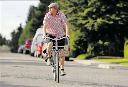  ?? Leah Hennel, Calgary Herald ?? Bike store owner Sean Carter rides his bicycle near his home in Rosscarroc­k, west of the Westbrook Mall. He welcomes new bike infrastruc­ture.