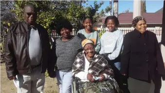  ?? Photo: Nadine Speelman ?? Gogo Maggie Nkomo (in front) celebrated her 100th birthday with family and friends. From left: Thami Pieter Nkomo (son), Miena Myburg (carer), Leabona Nkomo (great-granddaugh­ter), Ncebakazi Nkomo (great-granddaugh­ter) and Beatrice Nkomo (daughter-in-law).