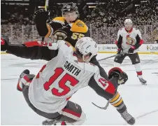  ?? STAFF PHOTOS BY NANCY LANE ?? MAKING AN IMPACT: Noel Acciari checks the Senators’ Zack Smith during yesterday’s game at the Garden; at left, Chris Wagner (center) celebrates his goal with Sean Kuraly (52) and Charlie McAvoy.