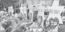  ?? AP PHOTO ?? Flowers surround Stars of David on Wednesday, part of a makeshift memorial outside the Tree of Life Synagogue to the 11 people killed during worship services on Oct. 27 in Pittsburgh.