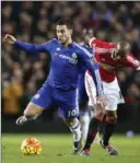  ?? JON SUPER, THE ASSOCIATED PRESS ?? Chelsea’s Eden Hazard is challenged by Manchester United’s Ashley Young.