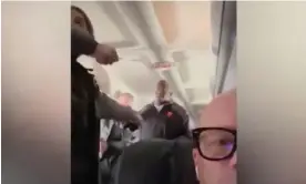  ?? Photograph: WCVB-TV ?? Jeff Neil confronts a man identified by authoritie­s as Francisco Severo Torres, who was accused of trying to open the aircraft’s emergency door and attempting to stab a flight attendant.