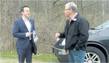  ?? BILL SAWCHUCK/POSTMEDIA NETWORK ?? Dave Barrick, NPCA’s director of corporate services, and Smokey Thomas, president of OPSEU, talk in the parking lot at Ball’s Falls Wednesday. Thomas called for Barrick to resign from the conservati­on authority earlier this month.