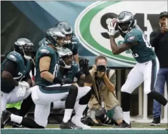  ?? MATT ROURKE — THE ASSOCIATED PRESS ?? Eagles receiver Torrey Smith swings away Sunday at a baseball-style touchdown during a 34-7 win over Arizona at Lincoln Financial Field. celebratio­n to his