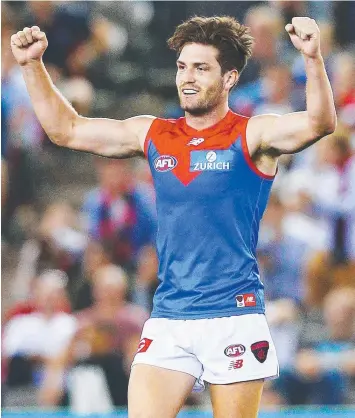  ?? Picture: MICHAEL DODGE ?? DEE-LIGHTFUL: Tomas Bugg celebrates Melbourne’s win over Hawthorn last night. Jake Melksham lays a high tackle on Carlton’s Matthew Kennedy (inset) earlier in the evening.