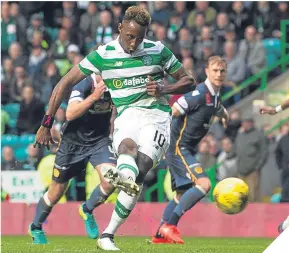  ??  ?? Moussa Dembele doubles Celtic’s lead from the penalty spot.