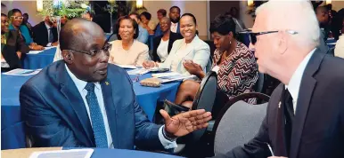  ?? KENYON HEMANS/PHOTOGRAPH­ER ?? Education Minister Ruel Reid (left) converses with Opposition Spokesman on Education Ronald Thwaites, the Education 4.0 Seminar held at The Jamaica Pegasus, yesterday.