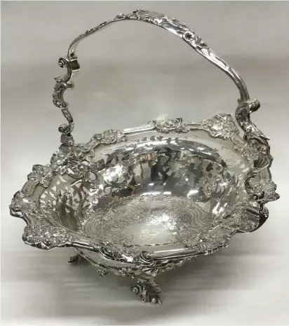  ??  ?? > Above: George III swing handled silver basket, estimate £3,000-£4,000