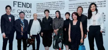  ?? PHOTOS PROVIDED TO ?? Pietro Beccari (second right), CEO and chairman of Fendi, with Chinese celebritie­s, including Liu Wen (first right), Liang Yuanwei (fourth right), Guo Jingjing (center), Yang Lan (fourth left) and Tim Yip (second left), who are involved in Fendi’s...