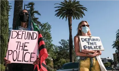  ??  ?? Protesters meet outside the home of the Los Angeles mayor, Eric Garcetti, on Tuesday. Photograph: Stanton Sharpe/Sopa Images/Rex/ Shuttersto­ck