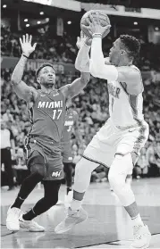  ?? [PHOTO BY NATE BILLINGS, THE OKLAHOMAN] ?? Oklahoma City’s Russell Westbrook, right, looks to shoot against Miami’s Rodney McGruder during Friday night’s NBA game at Chesapeake Energy Arena. The Thunder won the game, 105-99.