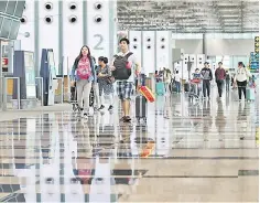  ??  ?? Passengers walk in Singapore’s Changi Airport Terminal 3. — Reuters photo