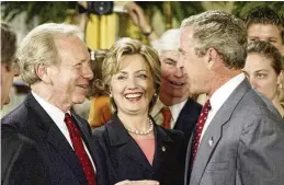  ?? CHUCK KENNEDY/TNS ?? Senators Joe Lieberman (D-Connecticu­t) and Hillary Clinton (D-New York) talk with President George W. Bush following a photo session with NCAA winter championsh­ip teams in the East Room of the White House in June 2003.
