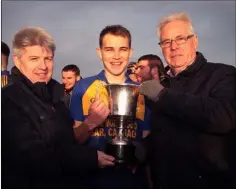  ??  ?? Andrew Egan, from sponsor Greenstar Recycling, and County Chairman Diarmuid Devereux present the winning cup to Gusserane O’Rahilly’s captain Sean Ryan.