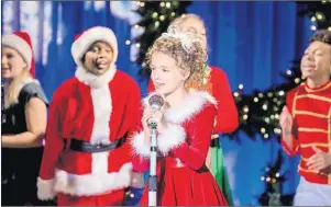  ?? BRIAN DOUGLAS/CROWN MEDIA VIA AP ?? Fina Strazza, center, in a scene from "A Christmas Melody," directed by Mariah Carey. Carey, Lacey Chabert, Brennan Elliott, Kathy Najimy and 10-year-old Broadway sensation Strazza star in the holiday special that premieres on Dec. 19 on the Hallmark...
