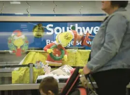  ?? E. JASON WAMBSGANS/CHICAGO TRIBUNE ?? Travelers wait in line for Southwest Airlines luggage services Tuesday after major service interrupti­ons at Midway Internatio­nal Airport.