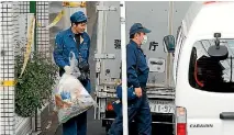  ?? PHOTO: REUTERS ?? A police officer carries a plastic bag from an apartment building where nine bodies were found in Zama, Kanagawa Prefecture, Japan.