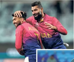  ?? AFP ?? Getting rid of the big fish: UAE’S Alishan Sharafu (left) and Ahmed Raza celebrate the wicket of Namibia’s David Wiese at Kardinia Park. Wiese had revived Namibia’s innings during the run chase of 149 but his dismissal was effectively the death blow to Namibia’s hopes of making it to the next round. UAE won by seven runs.