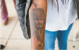  ?? THE NEW YORK TIMES ?? Teresa Lima shows a tattoo of Johnny Depp on her arm in Fairfax. Lima, a fan of the actor, traveled from Portugal to attend the trial between Depp and ex-wife Amber Heard.