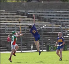  ??  ?? Carnew’s Padraig Doran climbs high to gather this dropping ball.