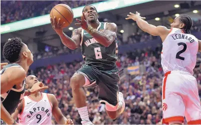  ?? FRANK GUNN/THE CANADIAN PRESS VIA ASSOCIATED PRESS ?? Milwaukee Bucks guard Eric Bledsoe (6) drives to the basket as Toronto Raptors foward Kawhi Leonard (2) attempts to defend during the first half of the Bucks’ win on Sunday.