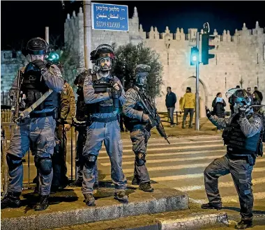  ?? PHOTO: GETTY IMAGES ?? Israeli police officers stand watch outside the Damascus Gate in the Old City in Jerusalem yesterday. Tension is high in Jerusalem after United States President Donald Trump’s announceme­nt recognisin­g Jerusalem as the capital of Israel.