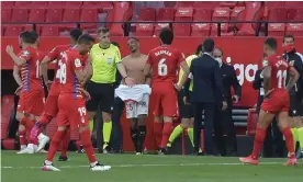  ?? Photograph: Cristina Quicler/AFP/Getty Images ?? Sevilla and Granada players return to the pitch to play one more minute after referee Ricardo de Burgos Bengoetxea blew for time early.