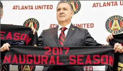  ?? BRANT SANDERLIN / BSANDERLIN@AJC.COM ?? Gerardo Martino doesn’t speak much English, but promised to learn by January, when the United start training. He won’t have to go far to learn — his wife is an English teacher.