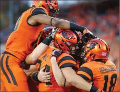  ?? AP PHOTO ?? Oregon State running back Ryan Nall, center, is mobbed by teammates after scoring a touchdown against California.