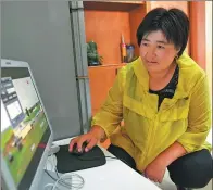  ??  ?? Herder Qiqige monitors her family’s prairie and herds using a computer at home.