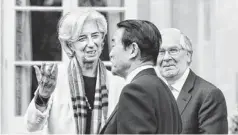  ?? ALASTAIR GRANT/AP ?? Christine Lagarde, managing director of the Internatio­nal Monetary Fund, talks to Taro Aso, Japan’s minister of finance, at the meeting of the G-7 finance ministers and central bank governors Friday in Aylesbury, England. Mervyn King, governor of the...