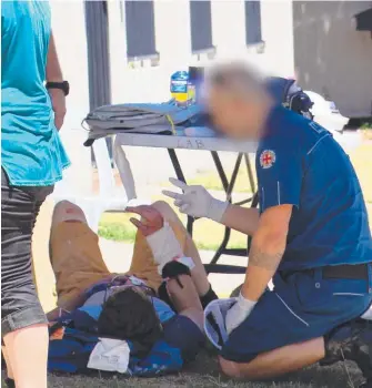  ?? Picture: CHANNEL 7 ?? An ambulance officer assists Andrew KIng after his accident.