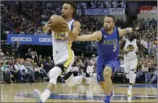  ??  ?? Golden State Warriors guard Stephen Curry (left) is chased by Dallas Mavericks guard J.J. Barea (right) during the first half of an NBA basketball game in Dallas on Monday. AP PHOTO/LM OTERO