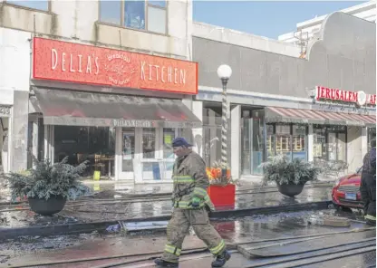  ?? MARK CAPAPAS/SUN-TIMES ?? A fire on Lake Street in downtown Oak Park on Tuesday damaged the restaurant Delia’s Kitchen as well as several other businesses and apartments.