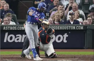  ?? TONY GUTIERREZ – THE ASSOCIATED PRESS ?? The Rangers' Leody Taveras drills a single during the seventh inning of Game 1of the AL Championsh­ip Series on Sunday.