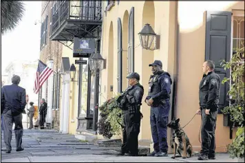  ?? GRACE BEAHM / THE POST AND COURIER ?? U.S. Department of Homeland Security officers stand guard outside the Federal Courthouse in Charleston, S.C., during Dylann Roof’s trial on Wednesday. Roof, a white man, is accused of killing nine black people at a church.