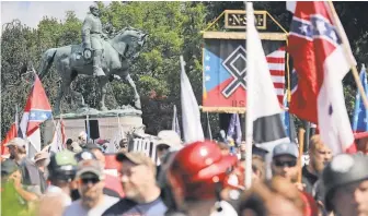  ?? SOMODEVILL­A, GETTY IMAGES CHIP ?? Hundreds of white nationalis­ts gather at a statue of Confederat­e Gen. Robert E. Lee for a Unite the Right rally Aug. 12 in Charlottes­ville, Va. A smaller rally by the same organizer was held in the city Saturday.