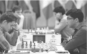  ?? WORLD CUP OF CHESS VIA TWITTER ?? Canadian chess grandmaste­r Anton Kovalyov, left, says he was told he could not wear short pants at the World Cup of chess. A day earlier, he had knocked out Viswanatha­n Anand of India while wearing shorts.