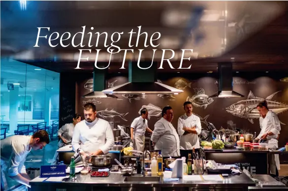  ??  ?? ABOVE: The chefs at work in the kitchen at the Sydney Seafood School