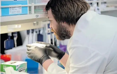  ?? Picture:CRAIG LASSIG/REUTERS ?? SAFETY RISK: Researcher Cody Hoffmann checks the results of an automated liquid handler as researcher­s begin a trial to see whether malaria treatment hydroxychl­oroquine can prevent or reduce the severity of the coronaviru­s disease at the University of Minnesota in the US