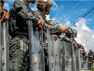  ?? PHOTOS: GETTY IMAGES ?? Venezuelan soldiers patrol the capital, Caracas, during an operation to capture Oscar Perez, a rebel against the government of Nicolas Maduro.